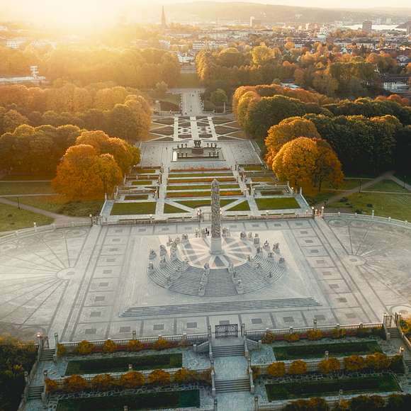 Overhead view of the Monolith and gardens in Oslo’s Frogner Park at sunset.
